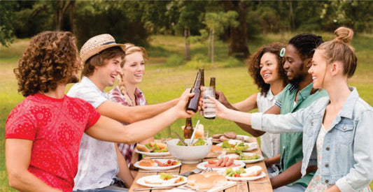Group of friends enjoying a picnic in a park, toasting with drinks on Masai Mara group joining safari game drives