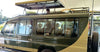 Green safari vehicle with open roof, driver guide and people inside, parked outdoors for rental safari holidays in Kisumu