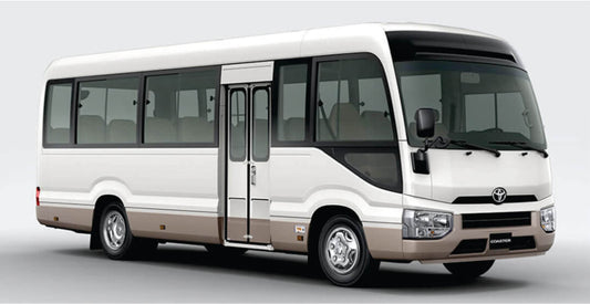 White group shuttle safari transfer bus with a visible Toyota logo on a gray background