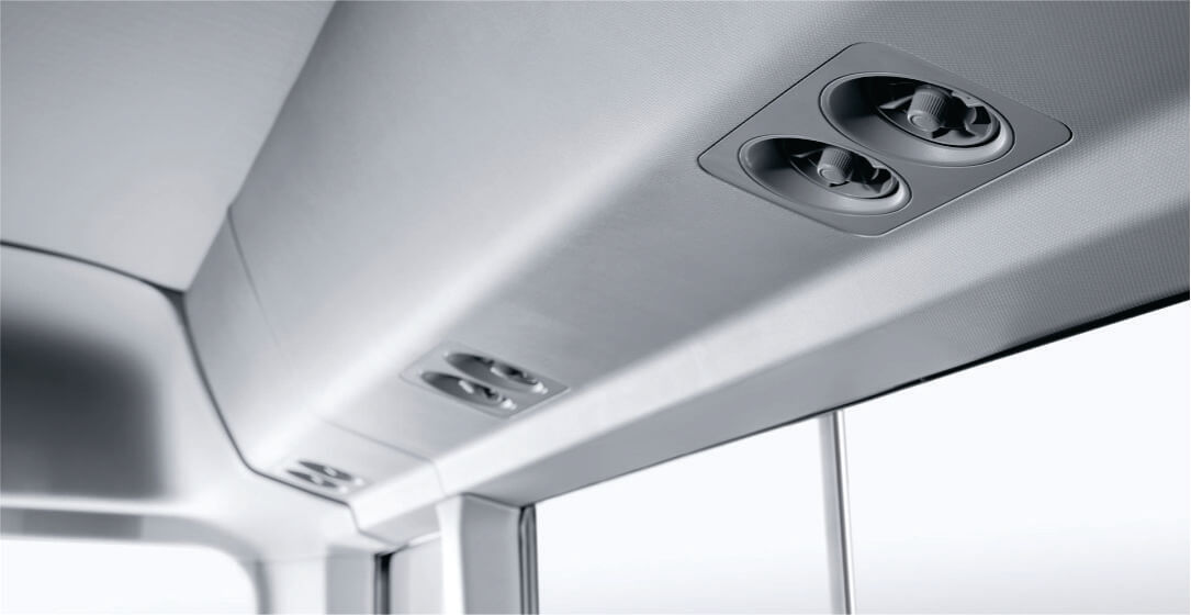 Close-up of an air conditioning system in the bus for rental in Nairobi with multiple lights and vents.