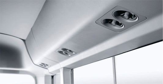 Close-up of an air conditioning system in the bus for rental in Nairobi with multiple lights and vents.