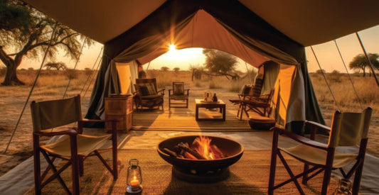 Tented accommodation with outdoor furniture and a fire pit in a safari setting.