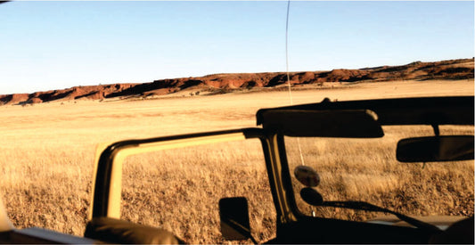 An open-roof top safari vehicle for rental in Masai Mara on game drives with an open door